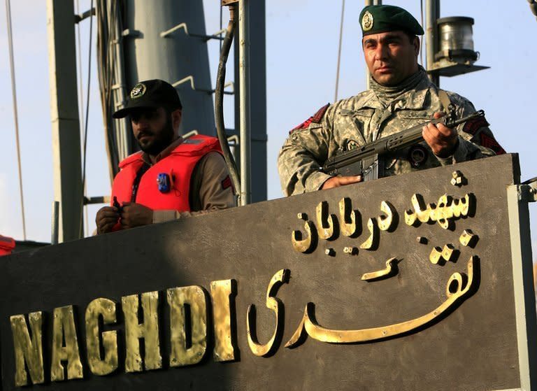 An Iranian navy special forces soldier (right) stands guard on Iran's Corvette Admiral Naghdi docked in Port Sudan, in October. Two Iranian warships docked in Port Sudan on Saturday, a witness said, marking the second port call by the Iranian navy in Sudan in five weeks