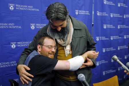 Will Lautzenheiser (L) hugs his partner Angel Gonzalez at a news conference to announce Lautzenheiser's successful double arm transplant at Brigham and Women's Hospital in Boston, Massachusetts November 25, 2014. REUTERS/Brian Snyder