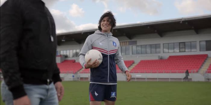 Dani Rojas smiles at Jamie Tartt on the pitch during practice