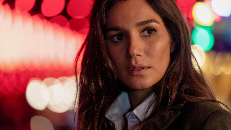 Mariela Garriga stands looking worried in a well lit night scene in Mission: Impossible - Dead Reckoning .