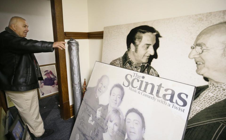 Ed George, former owner of Tangier, points to a photo of his father, Edward A. George, talking with entertainer Danny Thomas. The Scintas were one of the most popular acts in Tangier history.