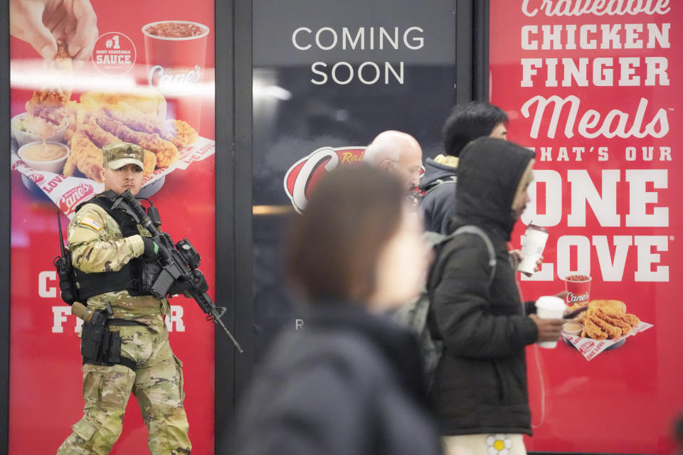 A heavily armed New York National Guard soldier stands guard at Penn Station, Thursday, March 7, 2024, in New York. New York Gov. Kathy Hochul announced plans Wednesday to send the National Guard to the New York City subway system to help police conduct random searches of riders' bags for weapons following a series of high-profile crimes on city trains. (AP Photo/Mary Altaffer)