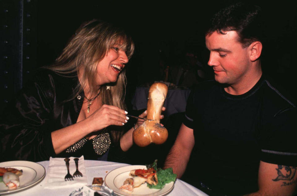 John Wayne Bobbitt looking at bread shaped like a penis