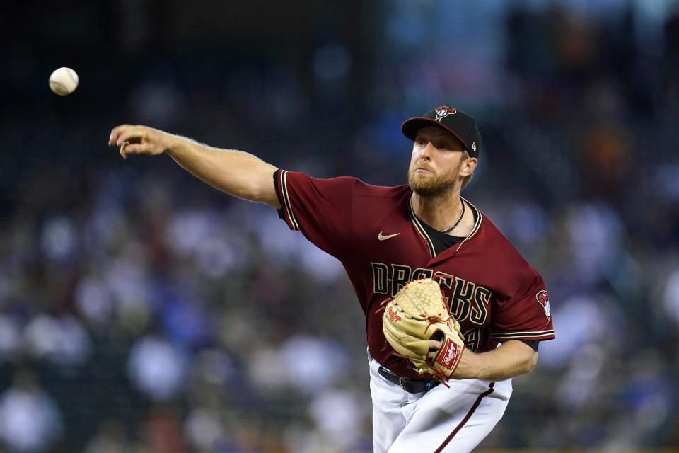 Arizona Diamondbacks starting pitcher Merrill Kelly throws to a Chicago Cubs batter during the first inning of a baseball game Sunday, July 18, 2021, in Phoenix. (AP Photo/Ross D. Franklin)