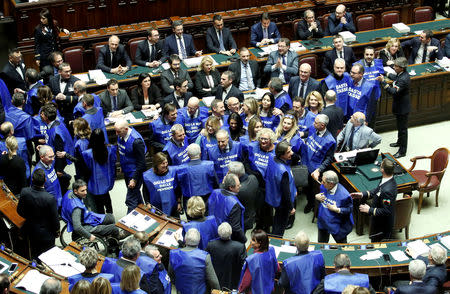 Members of Forza Italia party demonstrate during a final vote on Italy's 2019 budget law at the Lower House of the Parliament in Rome, Italy, December 29, 2018. Shirts read: "Hands off from pensions". REUTERS/Remo Casilli