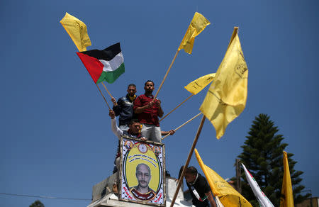 Demonstrators take part in a rally in support of Palestinian prisoners on hunger strike in Israeli jails, in Gaza City April 17, 2017. REUTERS/Mohammed Salem