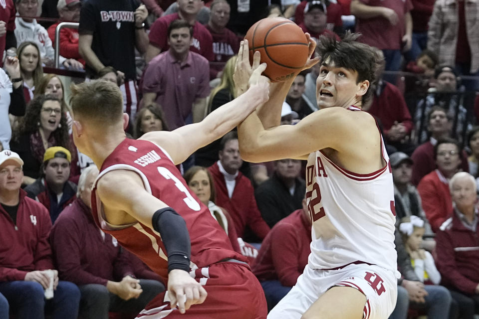 Indiana's Trey Galloway (32) is fouled by Wisconsin's Connor Essegian (3) as he shoots during the second half of an NCAA college basketball game, Saturday, Jan. 14, 2023, in Bloomington, Ind. (AP Photo/Darron Cummings)