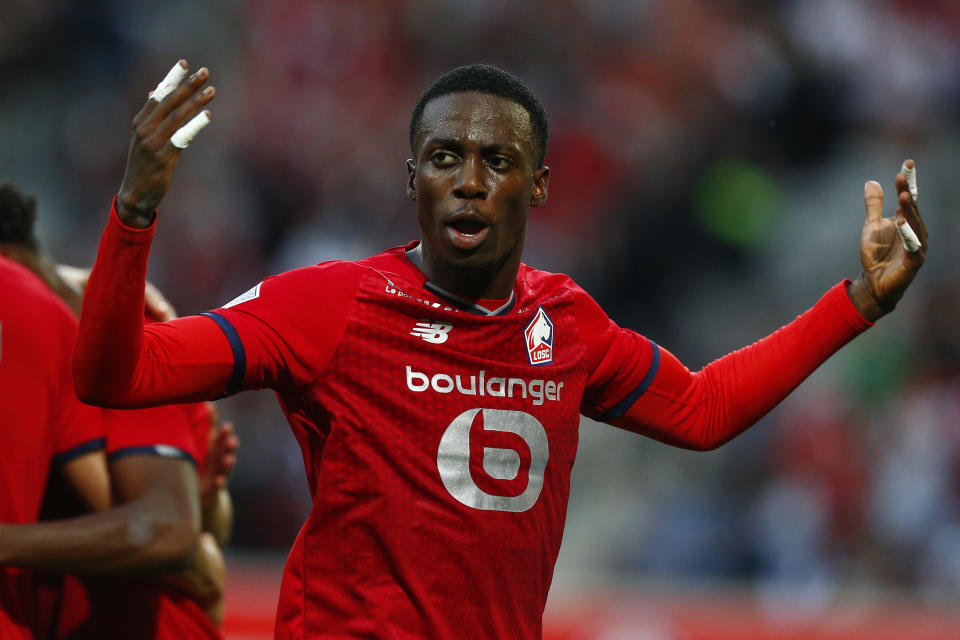 Lille's Timothy Weah celebrates after Lille's Jonathan David scored his side's opening goal during the French League One soccer match between Lille and Reims at the Stade Pierre Mauroy stadium in Villeneuve-d'Ascq, France, Wednesday, Sept. 22, 2021. (AP Photo/Michel Spingler)