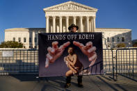 Stephen Parlato of Boulder, Colo., holds a sign that reads "Hands Off Roe!!!" outside of the Supreme Court in Washington, Tuesday, Nov. 30, 2021, as activists begin to arrive ahead of arguments on abortion at the court in Washington.(AP Photo/Andrew Harnik)