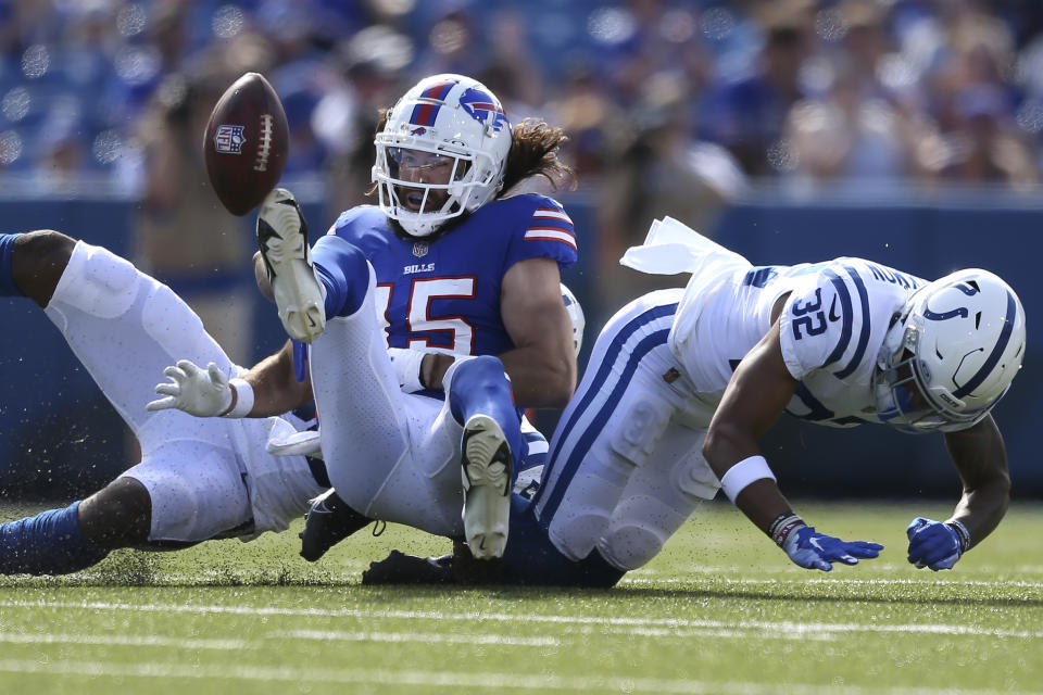 Indianapolis Colts linebacker Bobby Okereke, back left, and safety Julian Blackmon (32) force a fumble on Buffalo Bills wide receiver Jake Kumerow (15), center, during the first half of a preseason NFL football game, Saturday, Aug. 13, 2022, in Orchard Park, N.Y. (AP Photo/Joshua Bessex)