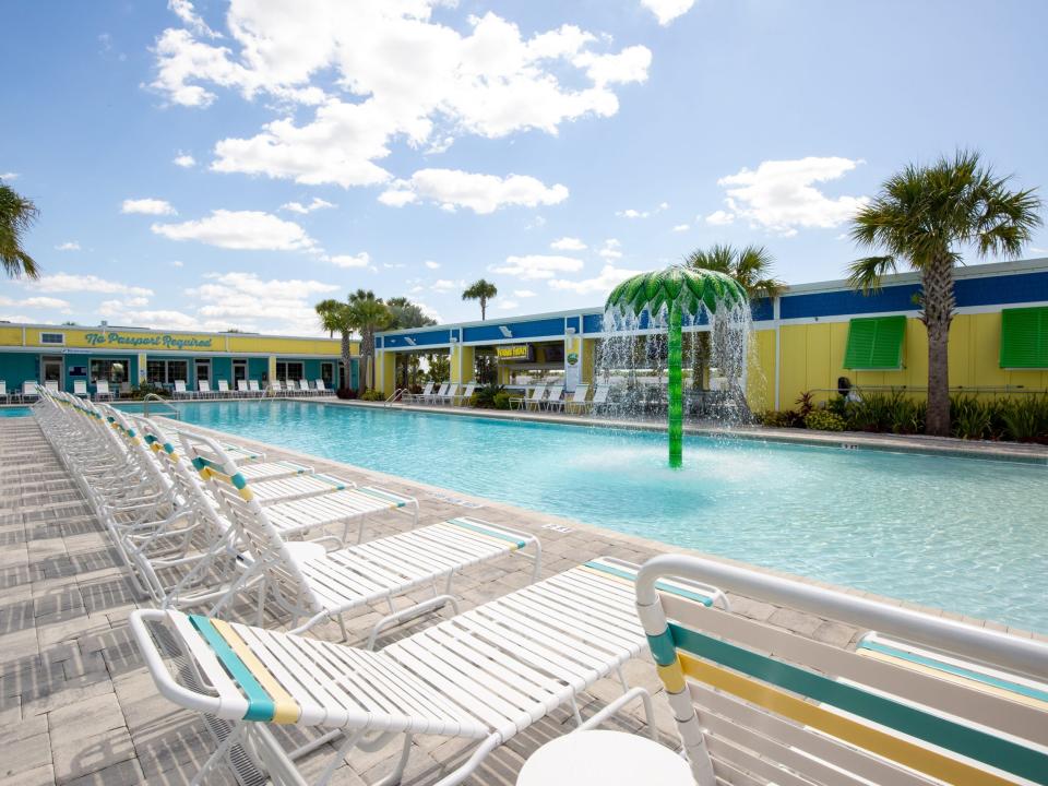 Beach chairs next to a pool.