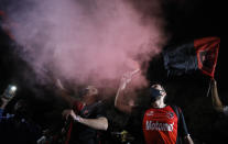 Men wearing protective face masks take part in a caravan organized by the soccer club fans of Newell's Old Boys in the hometown of Leonel Messi, in Rosario, Argentina, Thursday, Aug. 27, 2020. Fans are hoping to lure Messi home following his announcement that he wants to leave Barcelona F.C. after nearly two decades with the Spanish club. (AP Photo/Natacha Pisarenko)