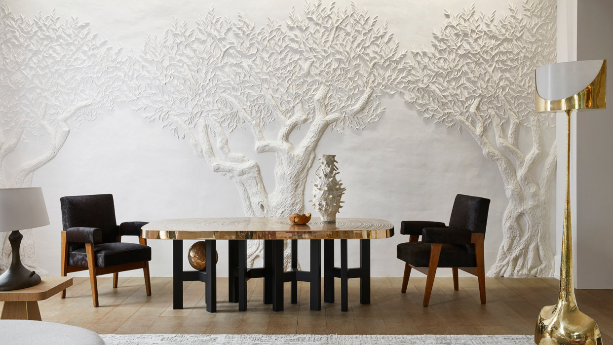  Embossed tree on white dining room wall with contemporary dining room table and sculptural vases. 