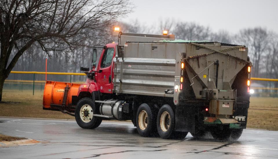A truck scatters salt as it drives through a Fishers residential neighborhood about an hour before rain is supposed to switch to snow, Wednesday, Feb. 2, 2022. The snow from the state-wide system, could crest six inches by morning, and continue to fall throughout Thursday. 