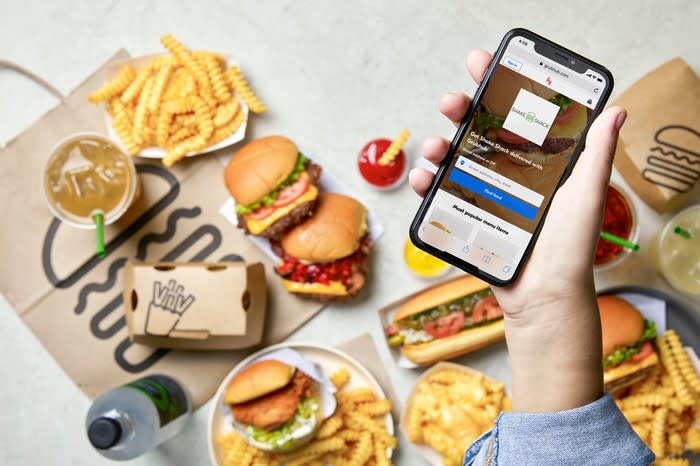 The Grubhub app with Shake Shack's food in the background.