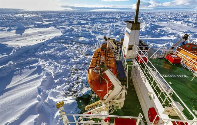 In this image provided by Australasian Antarctic Expedition/Footloose Fotography, Russian ship MV Akademik Shokalskiy is trapped in thick Antarctic ice, 1,500 nautical miles south of Hobart, Australia, Friday, Dec. 27, 2013. The research ship, with 74 scientists, tourists and crew on board, has been on a research expedition to Antarctica, when it got stuck Tuesday after a blizzard's whipping winds pushed the sea ice around the ship, freezing it in place. (AP Photo/Australasian Antarctic Expedition/Footloose Fotography, Andrew Peacock) EDITORIAL USE ONLY