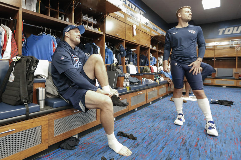 Tennessee Titans quarterback Ryan Tannehill, left, and punter Brett Kern, right, talk in the locker room before practice. (AP Photo/Mark Humphrey)