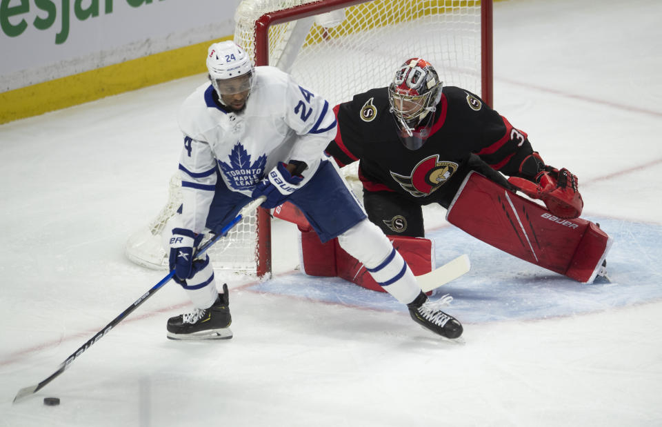 Toronto Maple Leafs right wing Wayne Simmonds controls the puck in front of Ottawa Senators goaltender Anton Forsberg during the first period of an NHL hockey game Wednesday, May 12, 2021, in Ottawa, Ontario. (Adrian Wyld/The Canadian Press via AP)