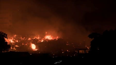 Flames engulf a slum after a fire broke out in Dhaka