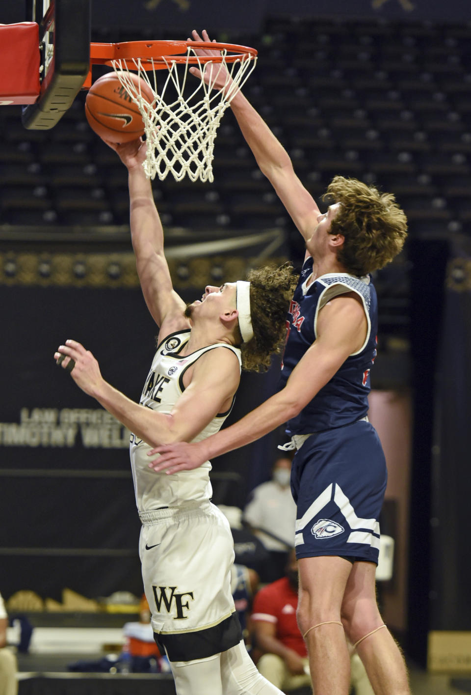 Wake Forest's Ismael Massoud gets past Catawba's Ben Bowen for a layup in an NCAA college basketball game, Thursday, Dec. 31, 2020, at Joel Coliseum in Winston-Salem, N.C. (Walt Unks//The Winston-Salem Journal via AP)