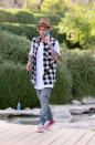 In between hanging out with his crew including the Jenner sisters, Hailey Baldwin, and Nash Grier, Justin Bieber took a phone call wearing a Nick Fouquet hat, distressed denim pants, a sleeveless gingham shirt, and red sneakers.