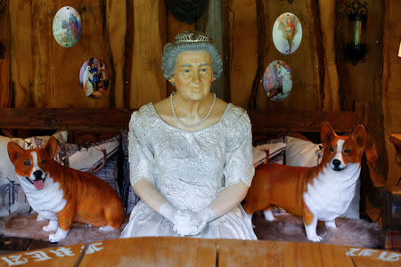 A model of Queen Elizabeth and two mock-up corgis are pictured at "Robin Hood's hut" at the British curiosities collection "Little Britain" of Gary Blackburn, a 53-year-old tree surgeon from Lincolnshire, Britain, in Linz-Kretzhaus, south of Germany's former capital Bonn, Germany, August 24, 2017. Picture taken August 24, 2017. REUTERS/Wolfgang Rattay