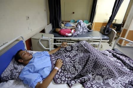 Rescued migrants lie in bed as they receives treatment at Rashid hospital in the port city of Rosetta, north of Cairo, Egypt, September 22, 2016. REUTERS/Mohamed Abd El Ghany