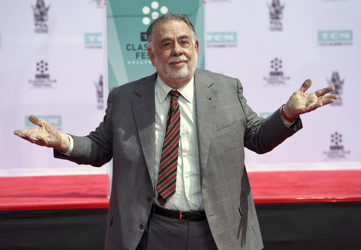 Francis Ford Coppola shows off his hands after placing them in cement during a handprint and footprint ceremony at the TCL Chinese Theater on Friday, April 29, 2016, in Los Angeles. (Photo by Chris Pizzello/Invision/AP)