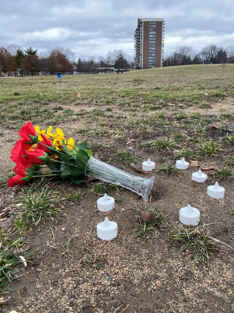 Artificial flowers and candles sit on the edge of Tarkington Park, where the Indy Steelers practice, on Jan. 20, 2023. The team's coach, Richard Donnell Hamilton, would be buried the next day.