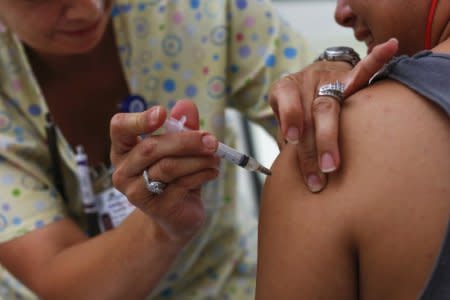 FILE PHOTO - A teenager receives a tetanus vaccination at the Remote Area Medical and Operation Lone Star joint health clinic at Palmview High School in Mission, Texas August 5, 2014.  REUTERS/Shannon Stapleton