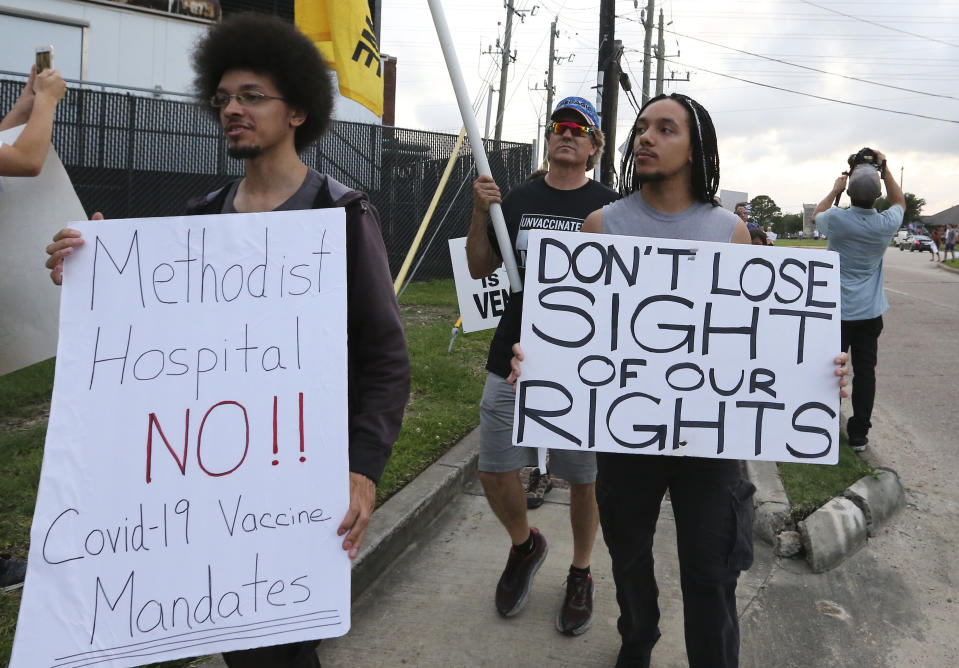 FILE - In this June 7, 2021, file photo, people march past Houston Methodist Baytown Hospital in Baytown, Texas, to protest against a policy that says hospital employees must get vaccinated against COVID-19 or lose their jobs. A federal judge dismissed their lawsuit, saying if workers don’t like the rule, they can go find another job. (Yi-Chin Lee/Houston Chronicle via AP, FIle)