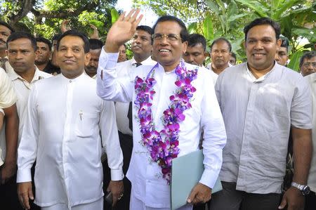 Sri Lankan Health Minister Mithripala Sirisena (C) waves as he arrives at a news conference in Colombo November 21, 2014. REUTERS/Stringer