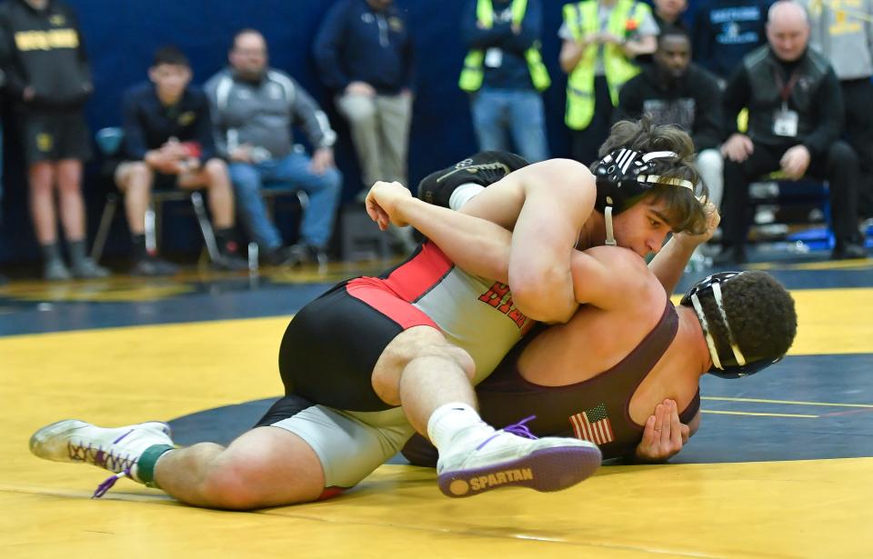 Hilton's Elijah Diakomihalis, top, wrestles Byron-Bergen's Malachi Smith in the final of the 190-pound weight class during the Teike-Bernabi Wrestling Tournament, Friday, Dec. 29, 2023.