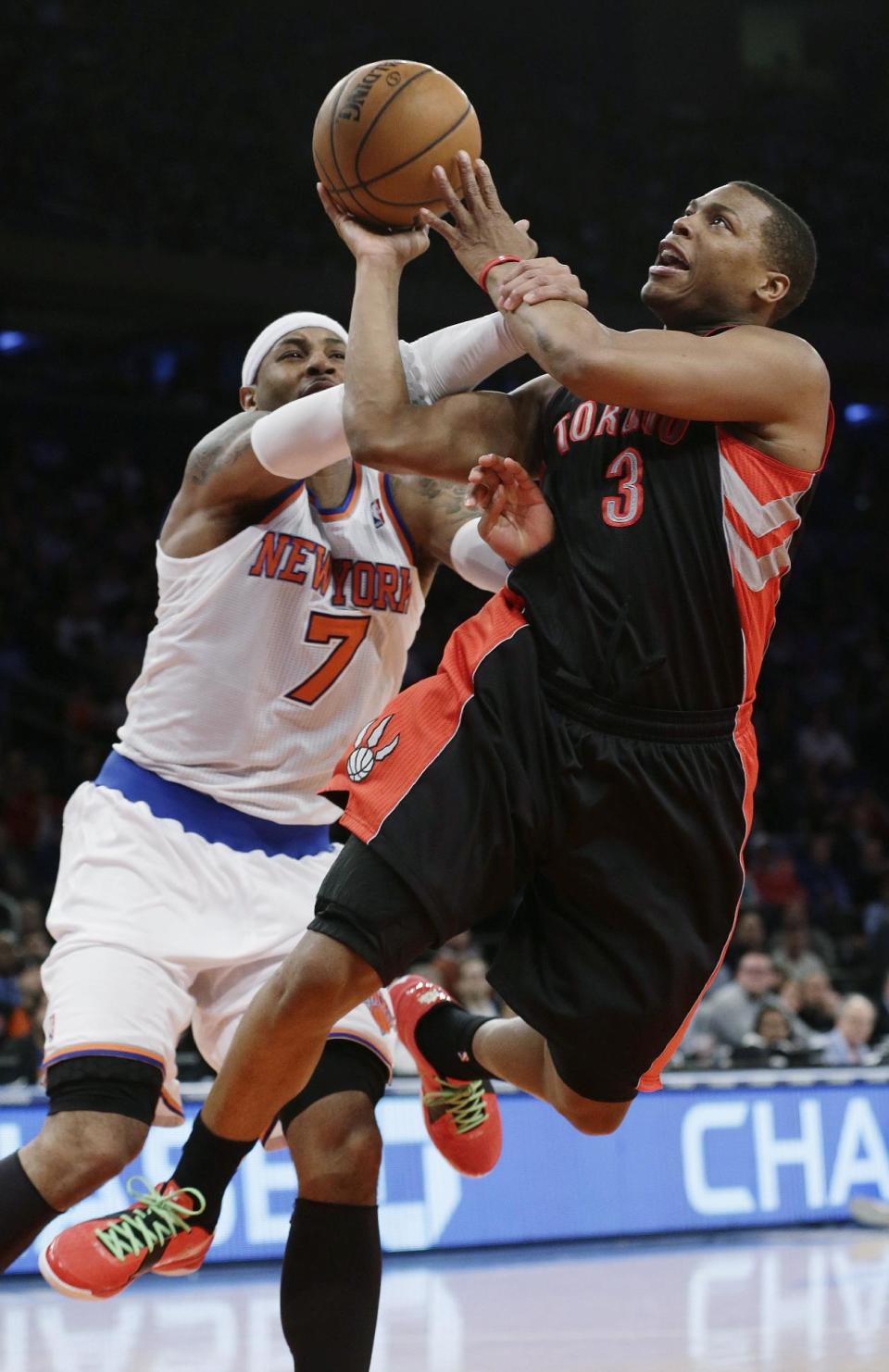 Toronto Raptors' Kyle Lowry (3) is fouled by New York Knicks' Carmelo Anthony (7) during the second half of an NBA basketball game Wednesday, Feb. 13, 2013, in New York. The Raptors won 92-88. (AP Photo/Frank Franklin II)