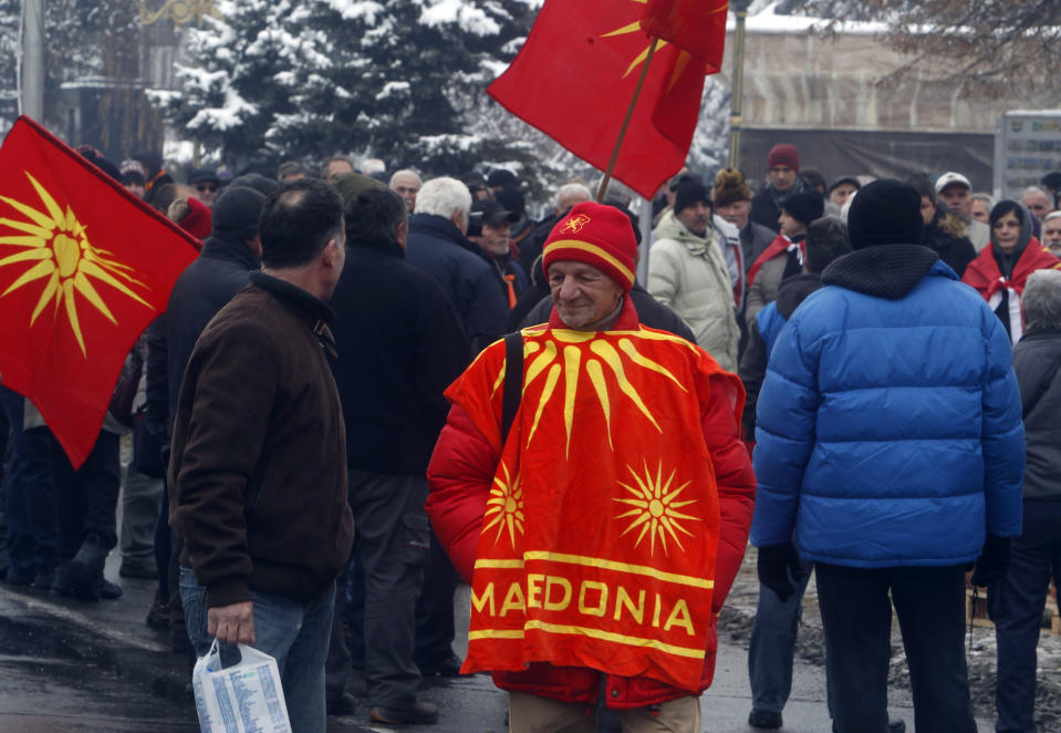 People attend a protest against the change of the country's name outside the parliament building during a session of the Macedonian Parliament in the capital Skopje, Friday, Jan. 11, 2019. Macedonia has fulfilled its part of a deal that will pave its way to NATO membership and normalize relations with neighboring Greece, after lawmakers approved constitutional changes that will rename the country North Macedonia. (AP Photo/Boris Grdanoski)