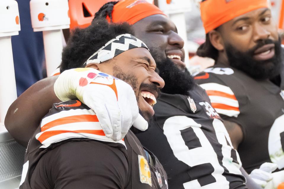 Cleveland Browns defensive end Myles Garrett (95) and defensive tackle Dalvin Tomlinson (94) celebrate against the Arizona Cardinals on Sunday in Cleveland.