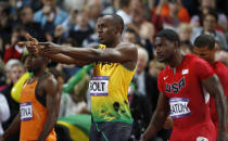 Jamaica's Usain Bolt, center, gestures before competing in the men's 100-meter final alongside United States' Justin Gatlin, right, and Netherlands' Churandy Martina, left, during the athletics in the Olympic Stadium at the 2012 Summer Olympics, London, Sunday, Aug. 5, 2012. (AP Photo/Matt Dunham)