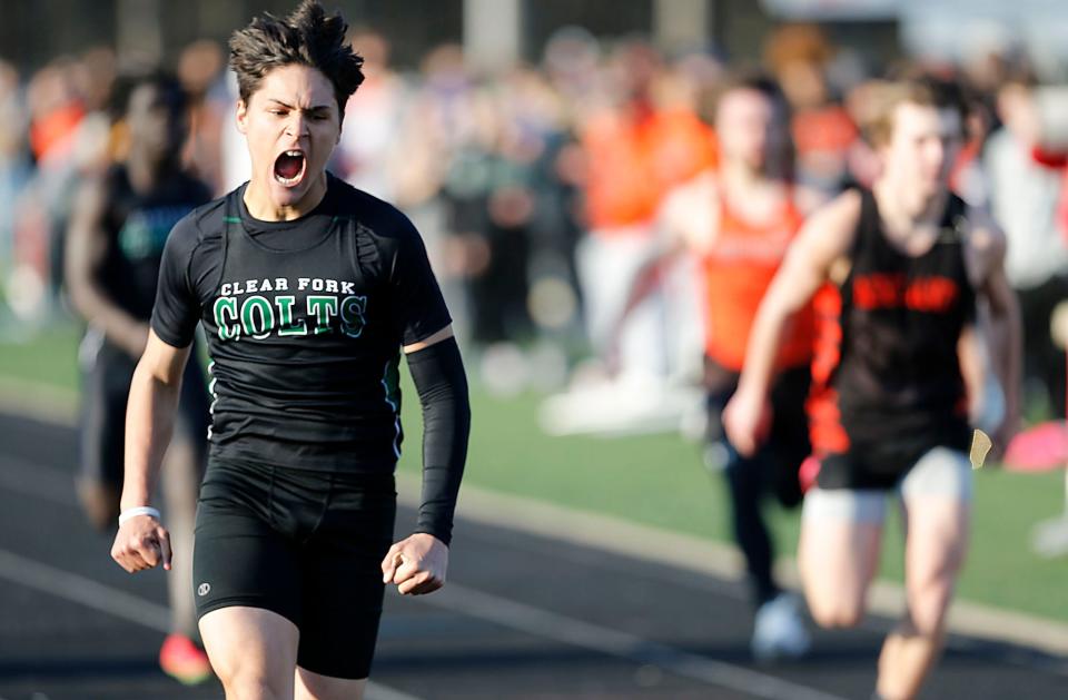 Clear Fork High School's Joe Stupka reacts after winning the 100 dash at the Madison Track Invitational at Madison Comprehensive High School Thursday, March 30, 2023. TOM E. PUSKAR/ASHLAND TIMES-GAZETTE