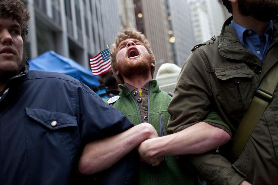 Protesters affiliated with the Occupy Wall Street movement lock arms at the intersection of Exchange Place and Beaver Street in the Financial District on Nov.17, 2011 in New York City. (Photo: Andrew Burton/Getty Images)