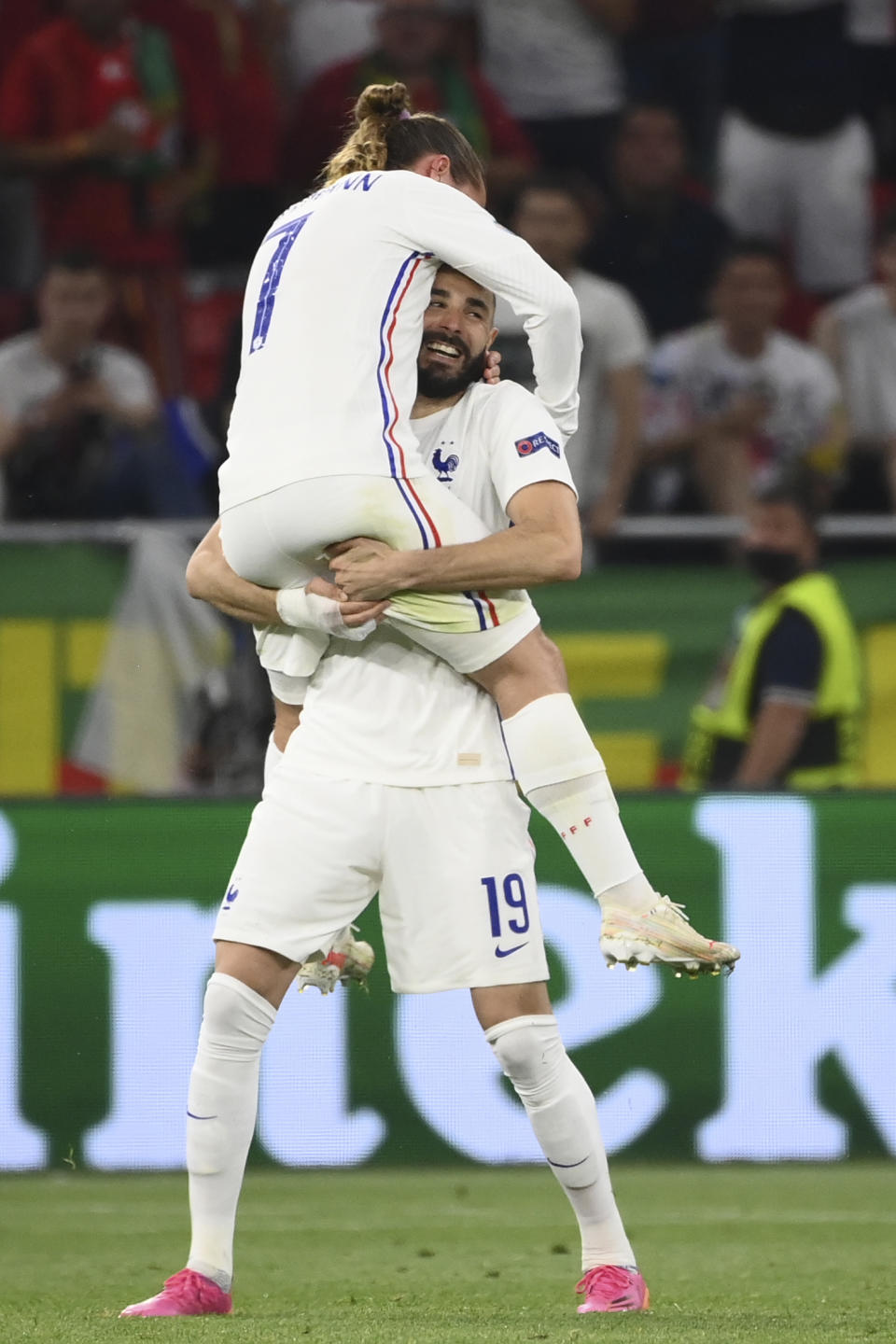 France's Karim Benzema celebrates with Antoine Griezmann, left,after scoring his side's second goal during the Euro 2020 soccer championship group F match between Portugal and France at the Puskas Arena in Budapest, Wednesday, June 23, 2021. (Franck Fife, Pool photo via AP)