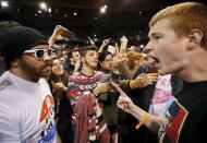 A Trump supporter (R) yells at a demonstrator (L) after Republican U.S. presidential candidate Donald Trump cancelled his rally at the University of Illinois at Chicago March 11, 2016. (REUTERS/Kamil Krzaczynski)