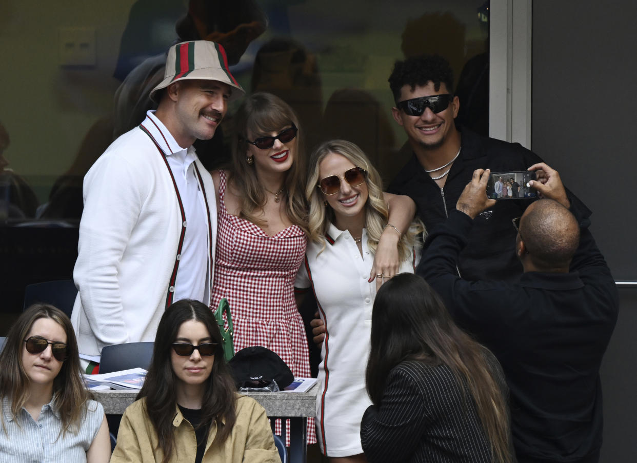 Travis Kelce, Taylor Swift, Brittany Mahomes and Patrick Mahomes pose for a photo.