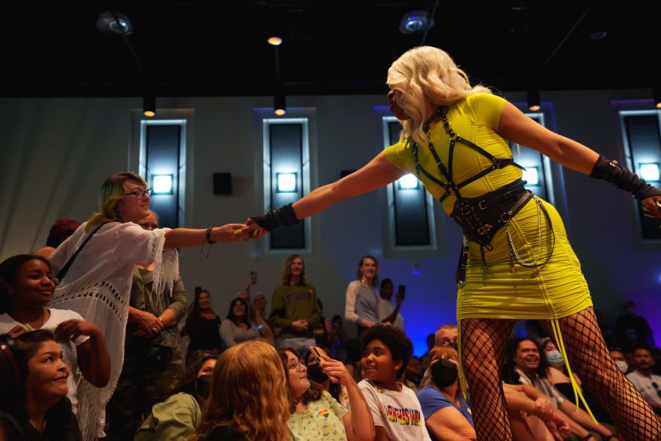 Té D. Demornay takes a dollar from an audience member while performing at Native Drag Night at the Heard Museum on June 3, 2022, in downtown Phoenix, AZ.