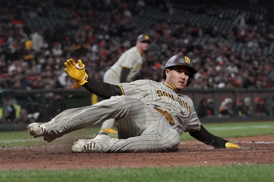 San Diego Padres' Manny Machado slides home to score against the San Francisco Giants during the second inning of a baseball game in San Francisco, Wednesday, Sept. 15, 2021. (AP Photo/Jeff Chiu)