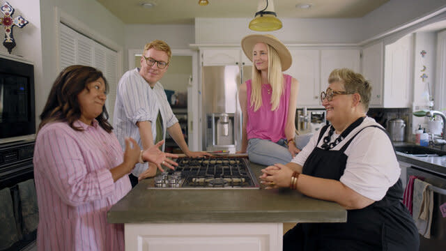 Johan, Katarina, Ella and Flora talking together in a kitchen.