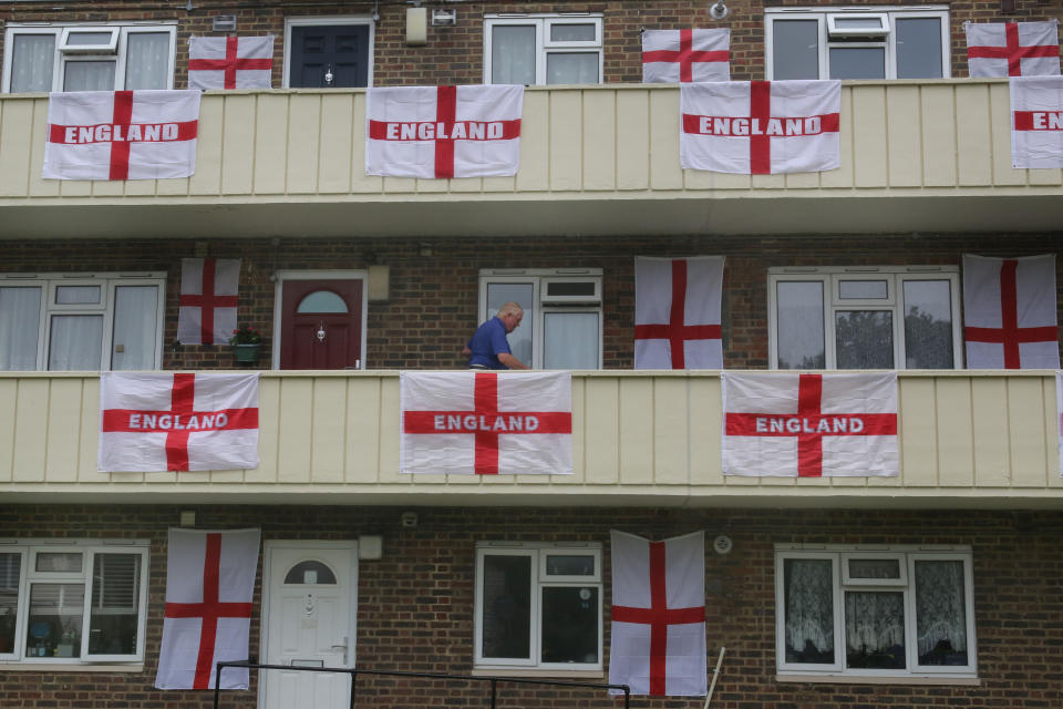 <p>LONDON, UNITED KINGDOM - 2021/06/27: England flags are draped over the balconies and are attached to the walls in support of the England team at the Euro 2020 championship.  After progressing to the top of their group, England now face Germany in the knockout section of the competition on Tuesday 29th June. (Photo by Martin Pope/SOPA Images/LightRocket via Getty Images)</p>
