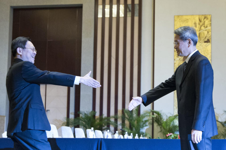 Wang Yu-chi, head of Taiwan's Mainland Affairs Council, left, shakes hands with Zhang Zhijun, director of China's Taiwan Affairs Office, right, before their meeting in Nanjing, in eastern China's Jiangsu Province, Tuesday, Feb. 11, 2014. Representatives of China and Taiwan met Tuesday in Nanjing for their highest-level talks since their split in 1949, a landmark step despite Beijing's refusal to recognize the self-governing island's sovereignty. (AP Photo/Alexander F. Yuan)