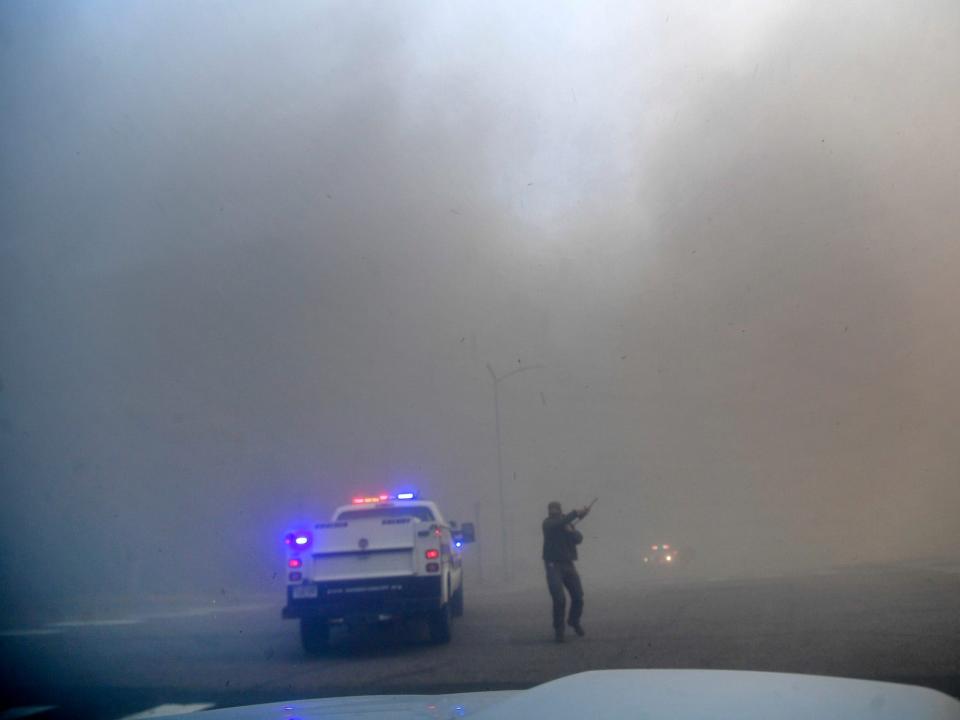 An officer with smoke-filled skies behind him in Colorado.