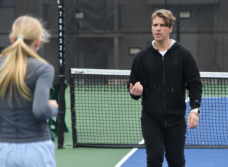 Personal trainer Justin Rollins works with Addie Duggins, 13, on the tennis courts at the Spartanburg Athletic Club.