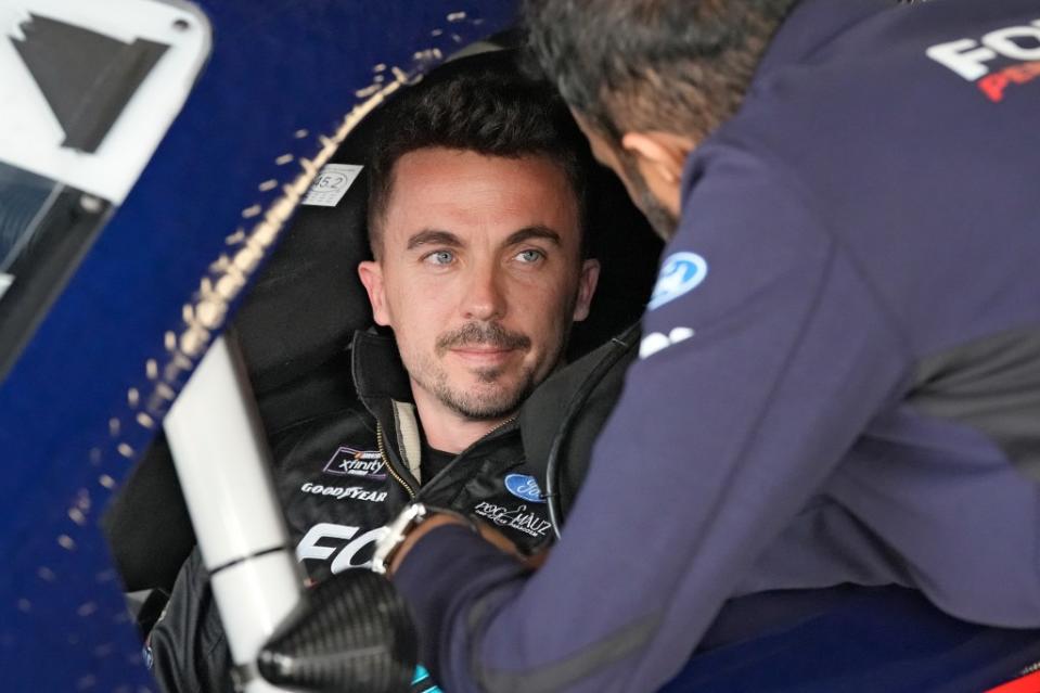 Feb. 16, 2024: professional race car driver Frankie Muniz talks to a crew member before a practice run at Daytona International Speedway. AP